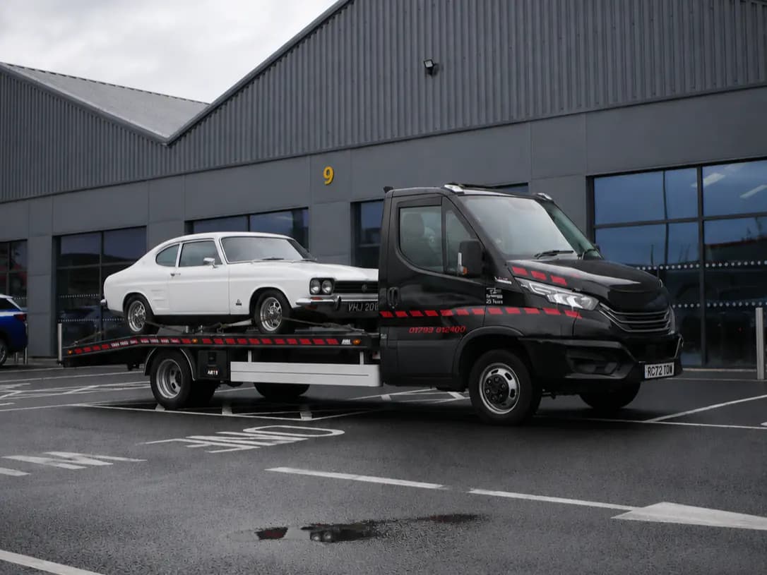 Classic car loaded for an auction collection run