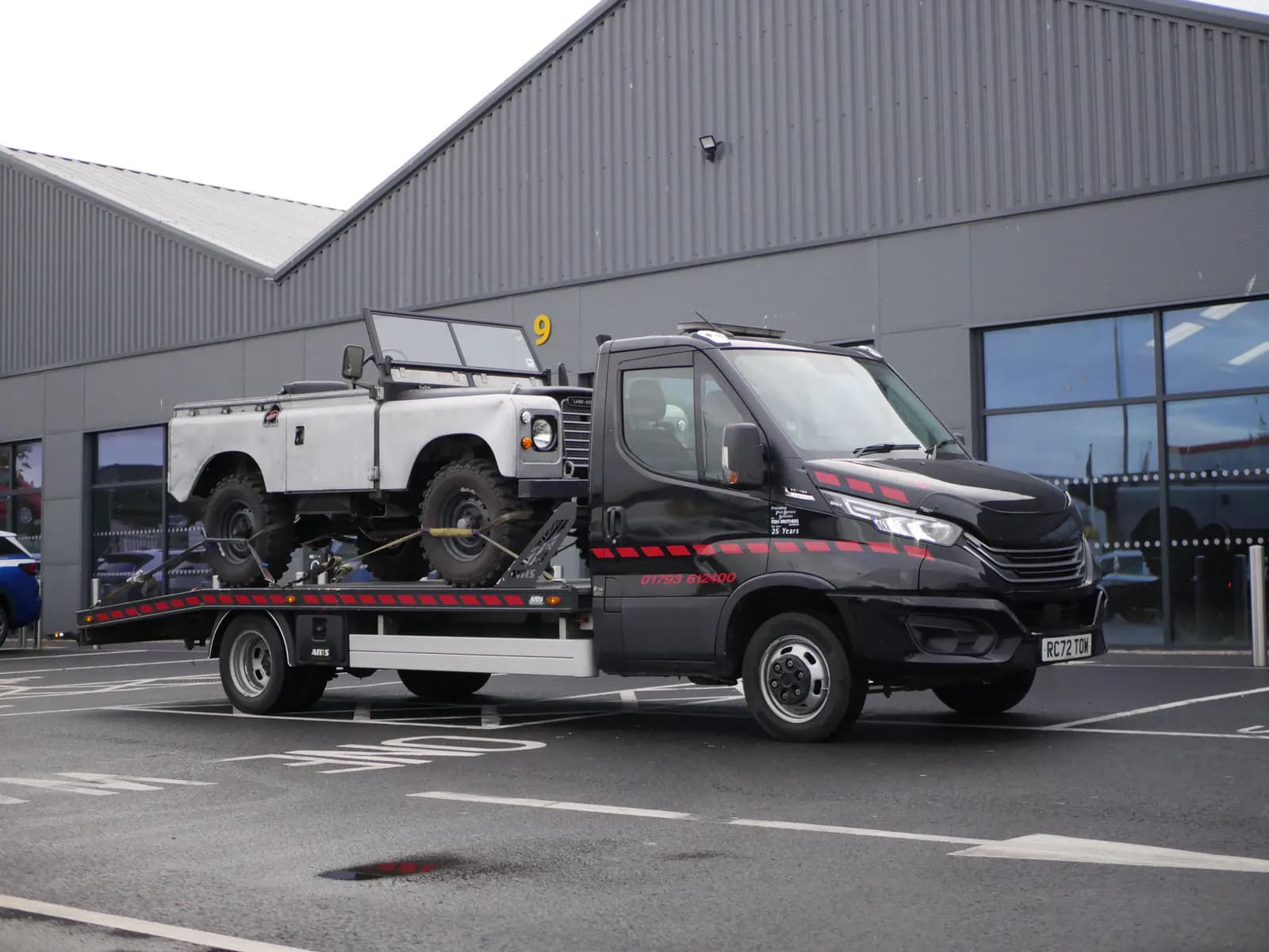 Classic Land Rover secured on a specialist transporter